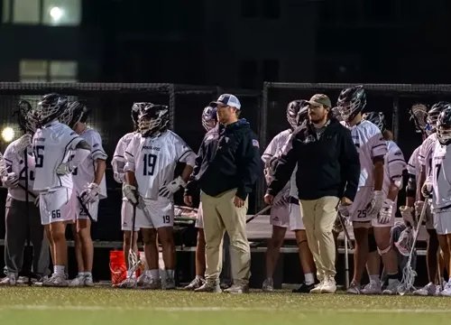 VWU Men's Lacross team on sideline with coach